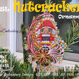 May include: A colorful embroidered Nutcracker ornament with the text "Nutcracker Ornament". The design features a red-coated Nutcracker soldier with a detailed face, surrounded by floral and snowflake accents. The ornament is displayed on a Christmas tree branch.