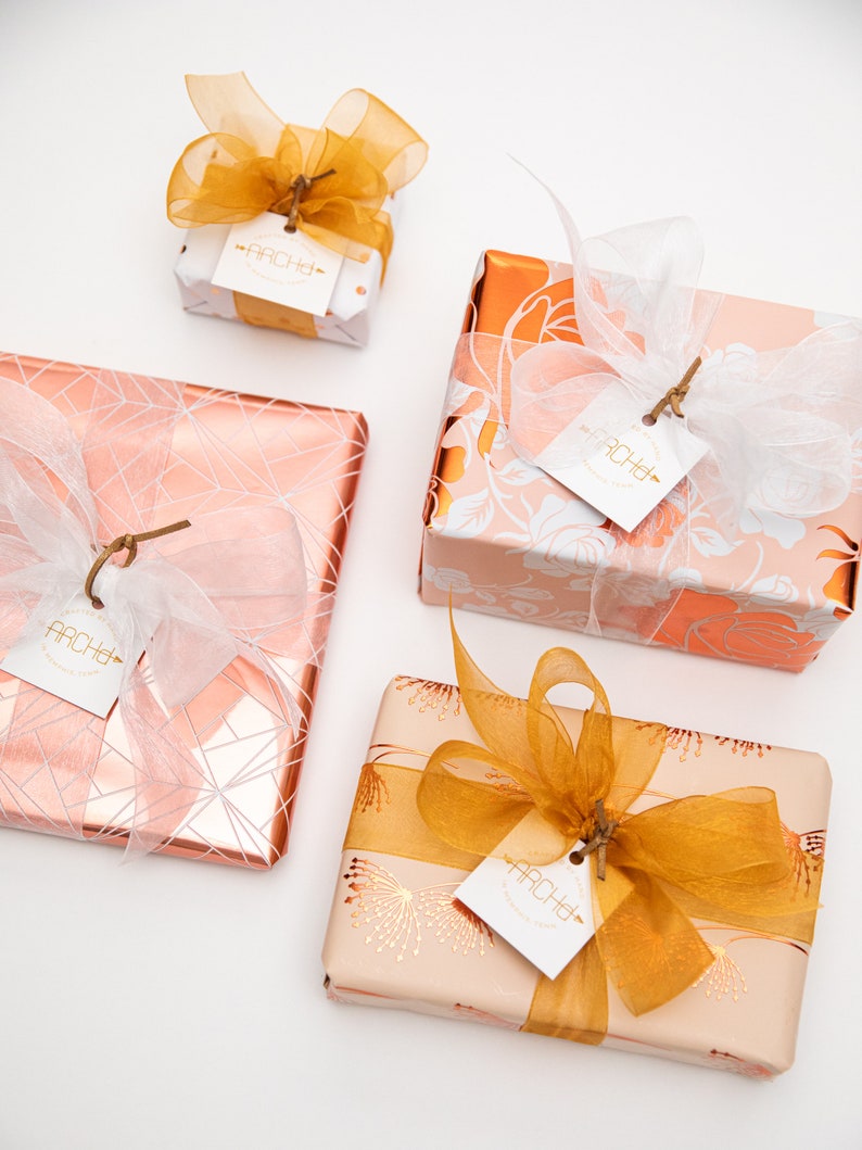 pink and copper gift wrap with white and gold ribbon