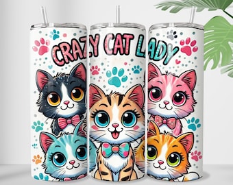 May include: Three stainless steel tumblers with a white background and colorful cartoon cats. The tumblers have the text "Crazy Cat Lady" printed on them.