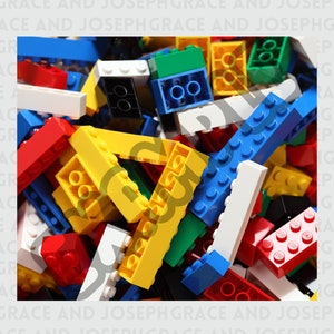 May include: A large pile of colorful plastic building blocks. The blocks are in various shapes and sizes, including squares, rectangles, and cylinders. The blocks are in shades of red, blue, green, yellow, and white.