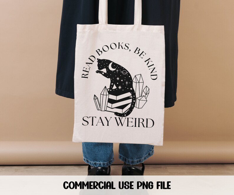 May include: A white tote bag with a black cat sitting on crystals and the text "Read Books, Be Kind, Stay Weird".