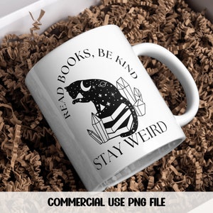 May include: White ceramic mug with a black and white illustration of a cat sitting on crystals. The text "Read Books, Be Kind, Stay Weird" is printed on the mug.