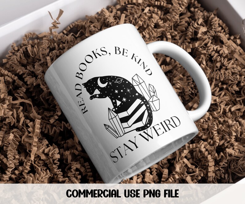 May include: White ceramic mug with a black and white illustration of a cat sitting on crystals. The text "Read Books, Be Kind, Stay Weird" is printed on the mug.