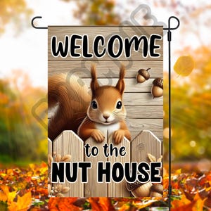 May include: A wooden garden flag featuring a squirrel and acorns. The flag reads "Welcome to the Nut House".