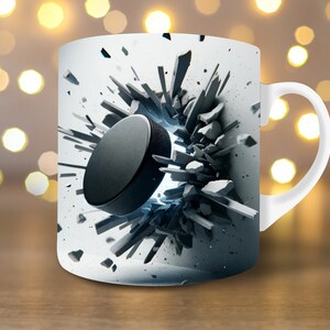 May include: White ceramic mug featuring a black hockey puck breaking through a wall of concrete. The puck is in mid-air and the concrete is shattered around it.