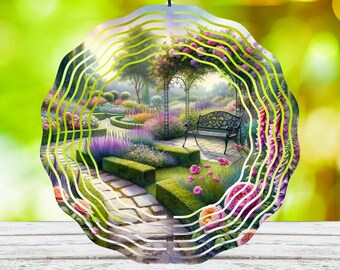 May include: A metal garden wind chime with a circular design. The chime features a colorful image of a garden with a bench, flowers, and a stone path. The wind chime is suspended from a black chain.