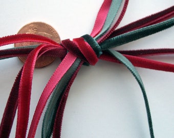 May include: A bundle of red and green velvet ribbon tied together with a knot. The ribbon is about 1/2 inch wide.