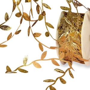 May include: Gold leaf garland with a metallic finish. The garland is made of a thin ribbon with leaves cut out of it. The garland is rolled up on a spool.