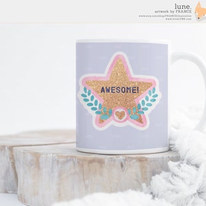 May include: White ceramic mug with a lavender background and a pink and gold star with the word "AWESOME!" in blue lettering. The star is surrounded by green leaves and a pink heart.