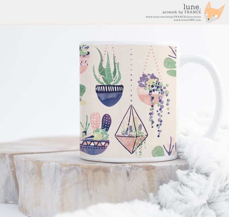 May include: White ceramic mug with a colorful pattern of hanging succulents and cacti. The pattern includes geometric shapes, pink, blue, and green colors.