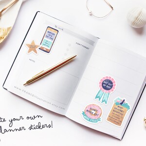 May include: A set of colorful planner stickers with various designs and text, including "Replied to a txt msg", "Got out of bed", "Didn't binge eat junk food", and "Went grocery shopping". The stickers are on a white background with a gold pen and a planner.