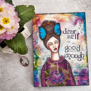 May include: A mixed media painting on canvas featuring a woman with blue butterfly hair clips. The painting has a colorful background and the text "dear self you are good enough" is written in black.