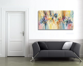 May include: Abstract painting with a colorful, textured design in shades of blue, yellow, pink, and white. The painting is hanging on a white wall above a gray sofa.