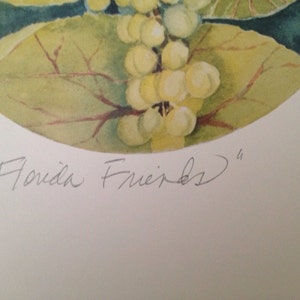 May include: Watercolor painting featuring a cluster of white berries and green leaves. The artwork is set against a dark blue background. The text "Florida Friends" is written in cursive below the image.