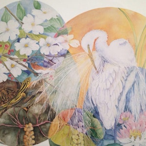 May include: Watercolor painting featuring a turtle, bluebird, and two white egrets. The artwork is set within overlapping circular frames, showcasing flora like white flowers, red berries, and pink water lilies. The background has a warm, orange glow.
