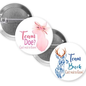 May include: Three round pinback buttons. One button features a pink deer silhouette with floral accents and the text "Team Doe? Can't wait to Know!". Another button has a blue floral deer design with the text "Team Buck Can't wait to Know!".