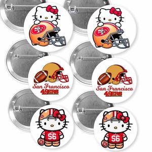 May include: A collection of round, silver-backed buttons featuring San Francisco 49ers football imagery. Designs include a football helmet, a football, and a cartoon character with a red bow. The buttons are white with red, gold, and black accents.