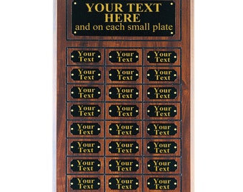 May include: A wooden plaque with a black background and gold lettering. The plaque has 20 smaller black plaques with gold lettering. The text on the large plaque reads "YOUR TEXT HERE and on each small plate".