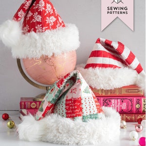 May include: Three quilted Santa hats in red, white, and green with white fur trim. The hats are arranged on a stack of books and a globe. The text "THE SNOW BOUND HAT" and "A QUILTED SANTA HAT SEWING PATTERN" is displayed below the hats.