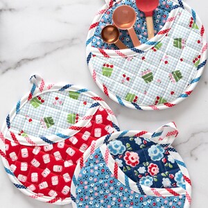 May include: Three quilted pot holders with a pocket. The pot holders are red, blue, and white with different patterns. The pot holders have a loop for hanging.