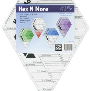 May include: A clear plastic quilting template with the text "Hex N More" and the Jaybird Quilts logo. The template is designed to cut hexagons, triangles, and jewels in various sizes. The packaging includes diagrams and instructions for use.