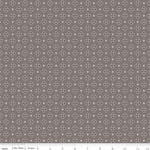 May include: A seamless fabric pattern with a repeating design of white snowflakes on a dark gray background.