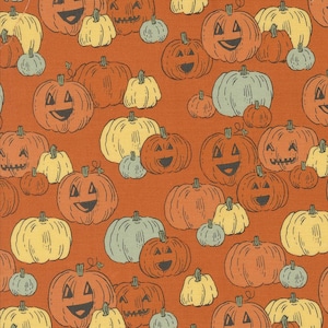 May include: Orange fabric with a repeating pattern of jack-o'-lanterns in various sizes and colors. The pumpkins have smiling faces and are in shades of orange, yellow, and blue-green. The background is a solid orange.