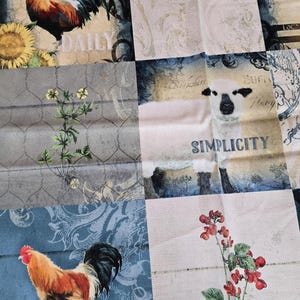 May include: A fabric panel featuring a grid of farm-themed squares. Designs include a rooster with sunflowers, a sheep labeled SIMPLICITY, a second rooster on a blue background, and botanical illustrations of green plants and red berries on neutral backgrounds.