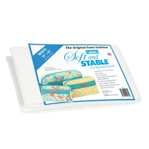 May include: A folded piece of white foam stabiliser with a product label that reads The Original Foam Stabiliser byAnnie's Soft and Stable. The label displays images of three small fabric pouches and lists dimensions of 45.7 cm by 147 cm.