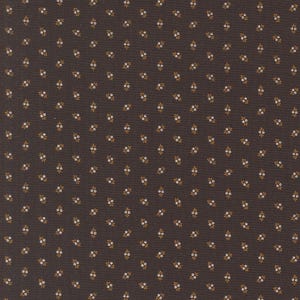 May include: Dark brown fabric with a repeating pattern of small white and gold floral sprigs. The fabric has a subtle texture, and the floral design is evenly distributed across the surface.
