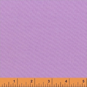 May include: A close-up of a solid lavender fabric swatch. The fabric is smooth and has a subtle texture. A ruler is placed at the bottom of the image, showing measurements in inches.