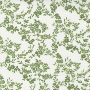 May include: White fabric with a repeating pattern of green roses and leaves. The floral design features detailed blooms and delicate foliage, creating a classic, vintage aesthetic. This fabric is suitable for various sewing and crafting projects.