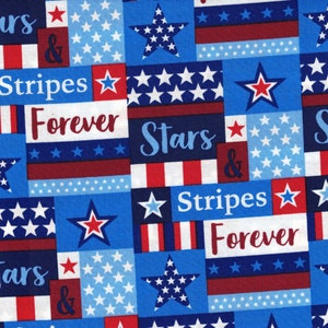 May include: A blue and red fabric with a repeating pattern of stars and stripes. The fabric has the text "Stars & Stripes Forever" repeated throughout the pattern.