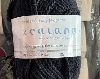 May include: A ball of black wool yarn labeled "zealand." Finest Quality Wool Yarn. The light, soft touch of new. 80% NZ Merino & 20% Cashmere blended yarn. Care Instructions: hand wash with care. Cool iron.