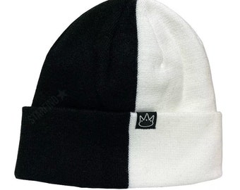 May include: Black and white knitted beanie with a crown logo on the side.