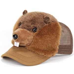 May include: A brown plush beaver-themed trucker hat featuring a soft, fuzzy beaver head with prominent white teeth, dark eyes, and a black nose. The cap includes a solid brown fabric brim and a breathable brown mesh back panel for ventilation.