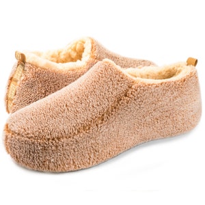 May include: A pair of soft, brown fuzzy slippers with a cream colored lining. The slippers are made of a plush, comfortable material.