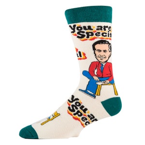 May include: White crew socks with a cartoon illustration of a man wearing a red jacket and blue pants. The socks have the text "You are Special" repeated on them.