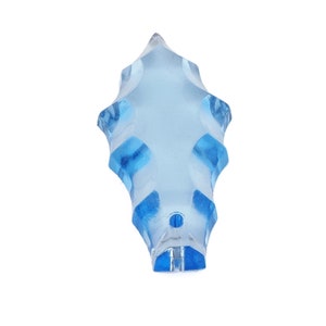 May include: A light blue crystal prism with a pointed tip and a faceted design. The prism is made of glass and has a clear, transparent appearance.