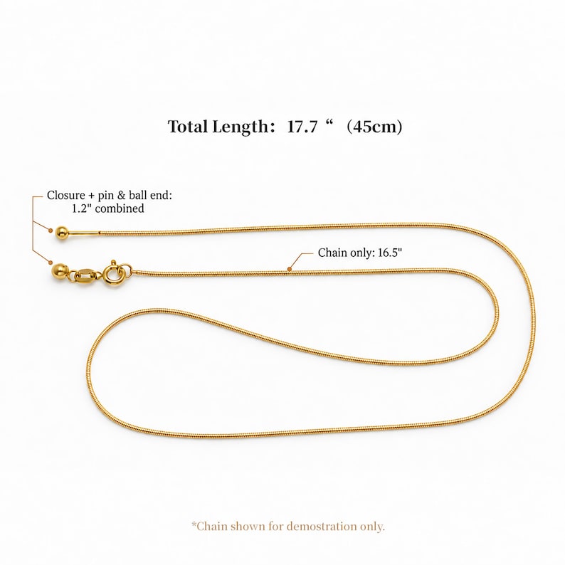 May include: A gold-toned snake chain necklace featuring a spring ring clasp and a pin and ball end. Text indicates a total length of 17.7 inches, a chain length of 16.5 inches, and a combined closure, pin, and ball end length of 1.2 inches.