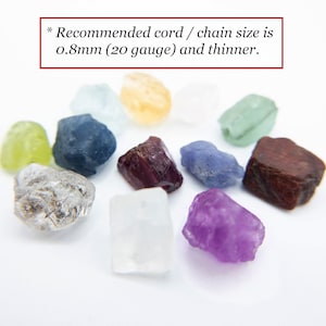 May include: A collection of small, raw, multi-colored gemstones including clear, yellow, green, blue, purple, and dark red pieces. Text at the top reads: * Recommended cord / chain size is 0.8mm (20 gauge) and thinner.