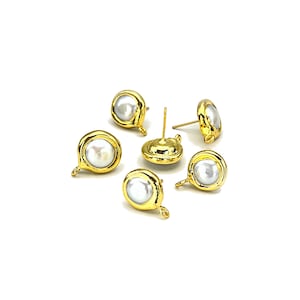 May include: Five gold-tone earring findings with white pearl-like cabochons. Each finding has a loop for attaching a dangle or charm.