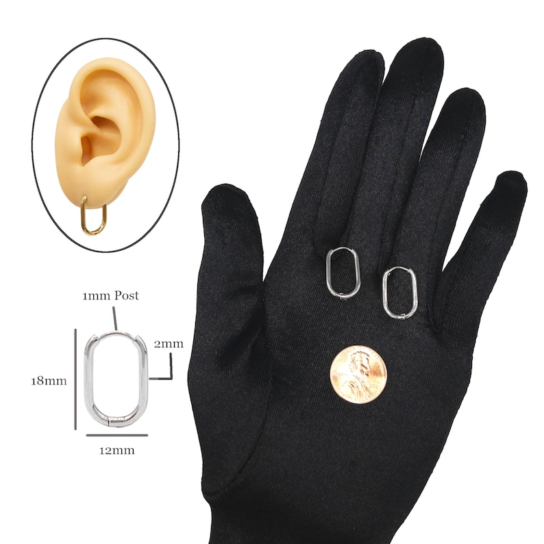 May include: A pair of silver oval hoop earrings with a 1 mm post and a 12 mm diameter. The earrings are shown on a black glove with a US penny for size comparison.