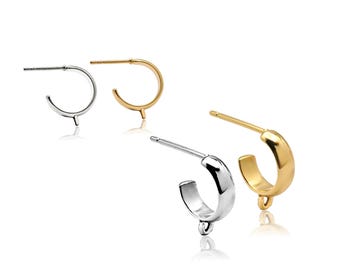 May include: Four hoop earrings with posts, presented in pairs of silver and gold tones. Each earring features a small circular loop at the base for attaching charms. The design includes a smooth, polished finish and a standard post-back mechanism.