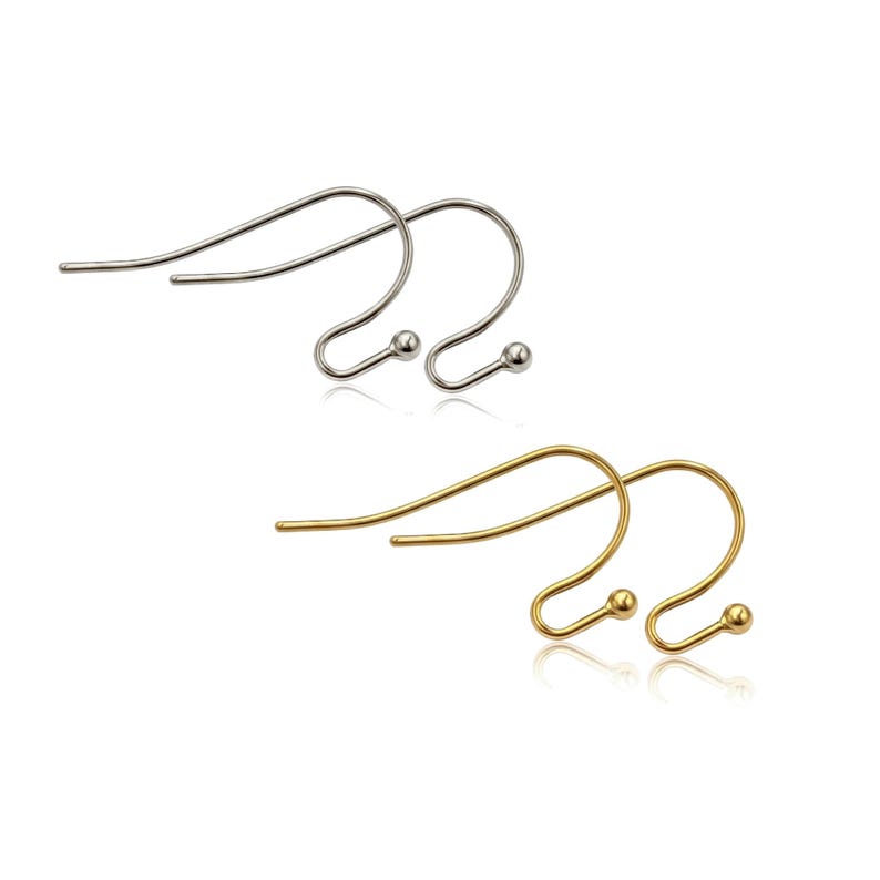 May include: A set of four earring hooks, featuring two silver-toned metal hooks and two gold-toned metal hooks. Each hook has a curved wire design with a small spherical bead at the end, designed for attaching jewelry components to the ear wire.