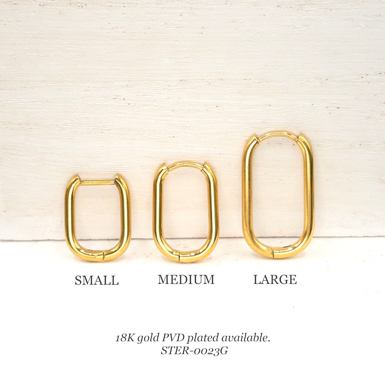 May include: Three gold-plated hoop earrings in different sizes: small, medium, and large. The earrings are oval-shaped and have a smooth finish. 18K gold PVD plated available. STER-0023G