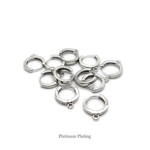 May include: A collection of small, circular, silver-toned metal hoop earrings with hinged closures and attached loops for charms. Each piece features a smooth, reflective surface with a platinum plating finish as indicated by the text Platinum Plating.