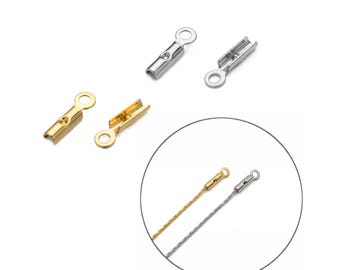 May include: A collection of metal crimp end findings in gold and silver tones. The components feature a cylindrical channel for securing cord or wire and a flat loop at one end for attachment. A circular inset shows the crimps attached to thin wires.