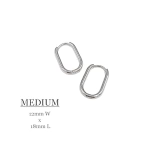 May include: Silver oval hoop earrings, measuring 12mm wide by 18mm long. MEDIUM.