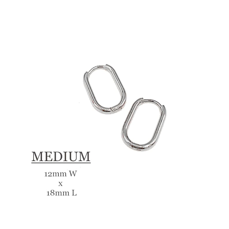 May include: Silver oval hoop earrings, measuring 12mm wide by 18mm long. MEDIUM.